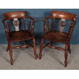 A pair of carved oak smokers bow armchairs. With turned column back rests and legs.