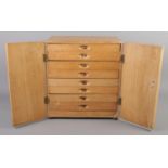 An oak and ply coin chest of drawers.