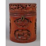 A Japanese bamboo tea caddy of cylindrical form, with carved scenes. 16cm high. Hinge missing.