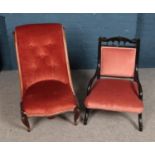 Two coral upholstered nursing chairs including buttoned example.