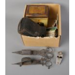 A box of assorted including a quantity of cigarette cards and pewter candlestick snuffers.