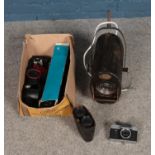 A box of assorted cameras to include boxed lens, film rolls, pair of binoculars and vintage studio