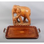 A carved wooden Elephant with calf and decorative tray featuring seashell motif.
