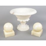 An alabaster pedestal bowl along with a pair of similar bookends.