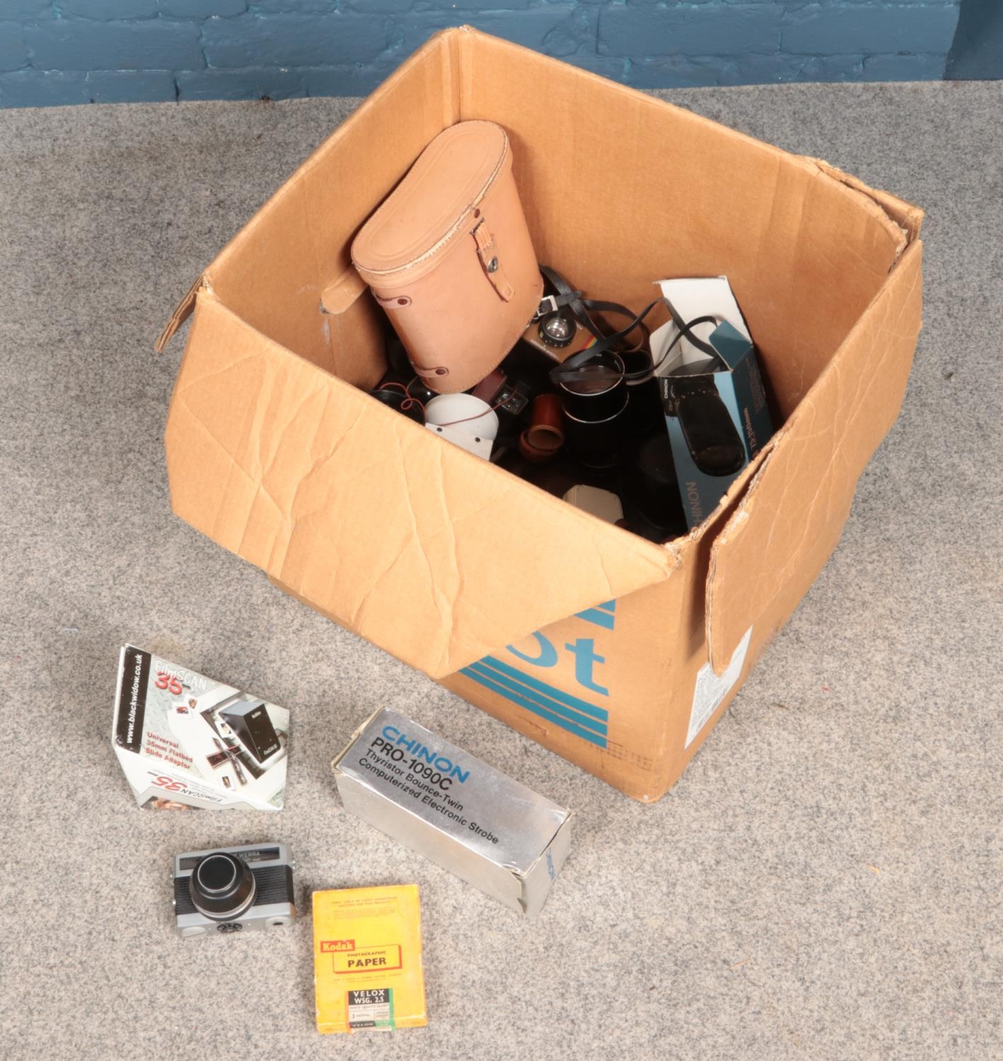 A large box of camera equipment and binoculars including Polaroid Land camera and Chinon 75-150mm