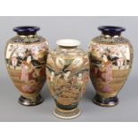A pair of blue ground Satsuma vases along with another similar example. Decorated with figures.