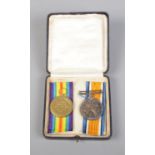 A pair of WWI medals in in case awarded to Private D.H Bailey, Tank Corps 97215.