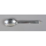 A George Jenson silver tea spoon. 16g.