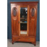 An Edwardian mahogany mirror front wardrobe. (206cm x 129cm)