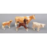 Four Beswick figures. Including cow and calf examples, etc.