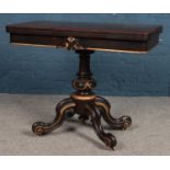 A Victorian fold-over card table, with gilt highlights, green baize insert and cabriole supports,