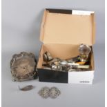 A box of assorted silver plate including cutlery, trophy and decorative belt buckle.