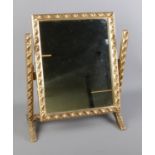 A gilt frame adjustable dressing table mirror. Frame features floral design. External dimensions