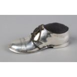 A novelty silver pin cushion in the form of shoe. Complete with cushion and laces around wooden