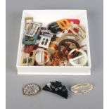 A quantity of miscellaneous belt buckles and hair accessories.