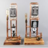 Two copper pipe mounted Jack Daniels optics, with table lamps.