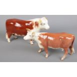 A Beswick Hereford bull and cow.