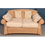 A large wicker 2 seat conservatory settee. Height: 87cm, Width: 157cm, Depth: 93cm.