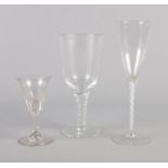 Two 18th century drinking glasses, along with a later air twist champagne flute.