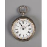 A silver pocket watch featuring floral border and roman numeral hour markers on face, keyless.