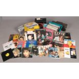 A large quantity of assorted single and album vinyl records, along with two vintage radios. To