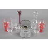 A collection of glassware. Includes Walther glass block vase designed by H Duesterhaus.