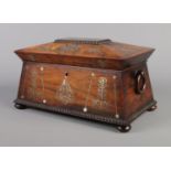 A Victorian rosewood tea caddy of sarcophagus form, having mother of pearl inlay and wooden loop