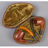 A cased pair of Victorian smoking pipes, with wooden bowls and silver mounts. Assayed Birmingham