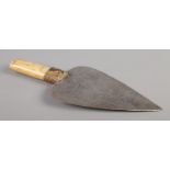An antique African ceremonial knife with bone and snakeskin handle and with hammered decoration to