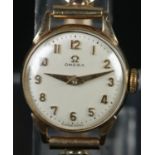 A ladies 9ct gold Omega manual wristwatch with 9ct gold expanding bracelet strap.