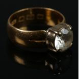 A 22ct gold ring set with a white paste stone. Size J. 4.53g.