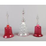 Three Victorian glass bells. Includes marble swirl example and two cranberry coloured examples.