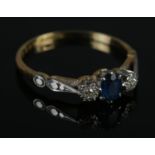 An 18ct gold & platinum sapphire and diamond ring. Size P, 2.20g.