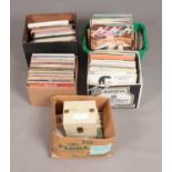 Five boxes of assorted records including several singles. To include artist such as David Bowie,