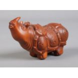 A Chinese carved boxwood figure of a rhinoceros. Height 4cm, Length 7cm.