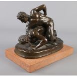 After Tupton, a bronze sculpture, The Wrestlers, raised on marble plinth. 23cm.