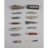 A collection of pen knives including engraved commemorative examples and footprint mini knife.