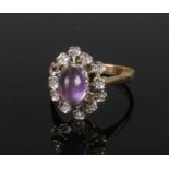 An 18ct Diamond and Amethyst ring with oval shaped cabochan and twelve diamond undulating collar.