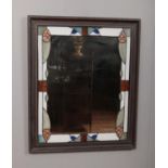 A stained glass edge mirror in wood frame. Dimensions including frame 83.5cm x 70cm.