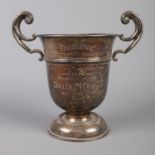A silver twin handled cup presented for the Gugnunc Putting Tournament by The Daily Mirror. Part