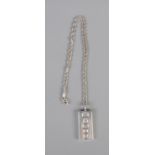 A silver ingot necklace on a rope chain. Hallmarked Sheffield 1977. 33.6g.