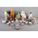 A box of orientalwares. Includes ceramic Japanese tea set, Buddha figure, two Tang style ceramic