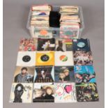 A large box containing an assortment of singles records. Top include Elton John, Status Quo, Spandau