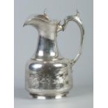 A silver plated hot water pot decorated with military figures. 25cm.