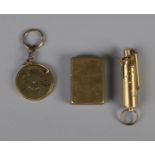 Two brass lighters including Zippo and Champ. Also includes 50 year nautical theme calendar keychain