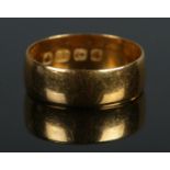 A 22ct Gold wedding band, assayed for Birmingham. Size KÂ½. Total weight: 3.31g