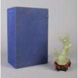 A carved Jade figure group modelled as a young girl with two sheep, raised on hardwood stand. Boxed.