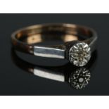 A 9ct Gold, Platinum and Diamond solitaire ring. Size JÂ½. Total weight: 1.57g