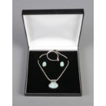 A silver and oval turquoise necklace and earring set. In original box.