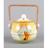 A Clarice Cliff Bizarre Fantasque biscuit barrel decorated in the Windbells design. Shape No. 335.